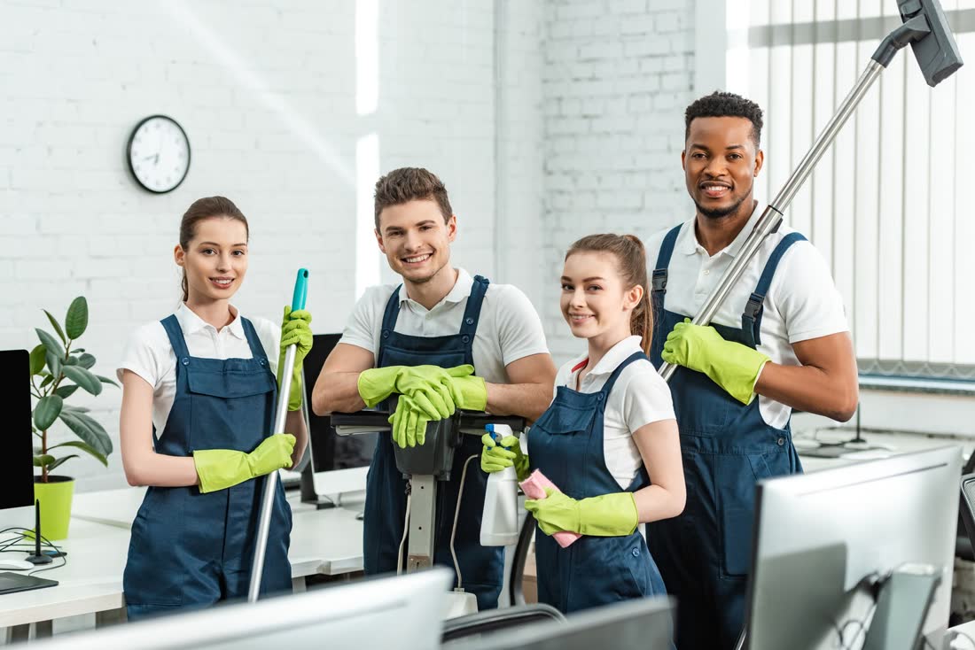 The Hogan Cleaning Services team at work in a bright office